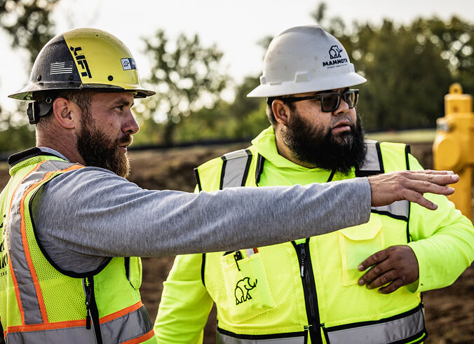 Construction workers surveying a construction project